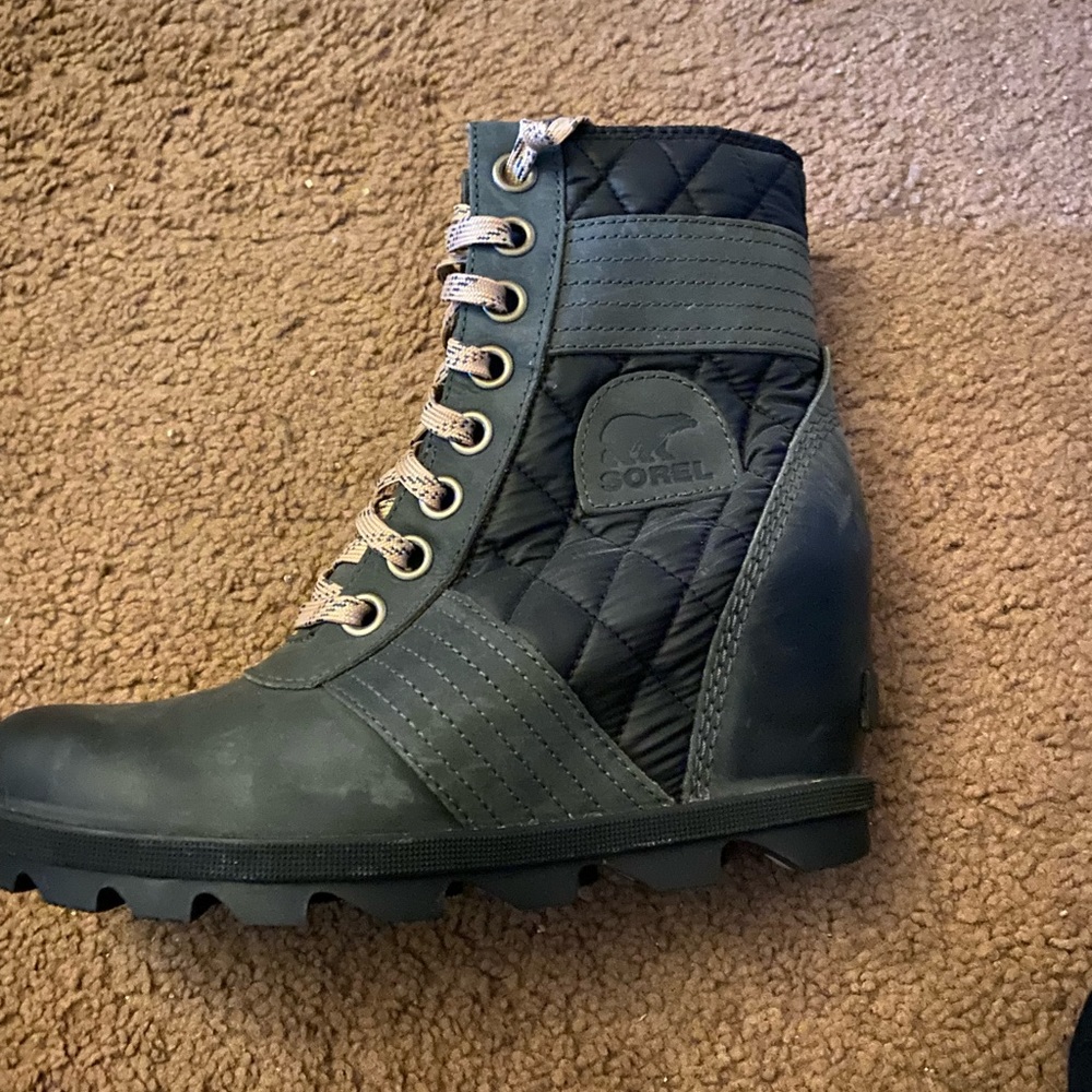 Green and black Sorel brand boots